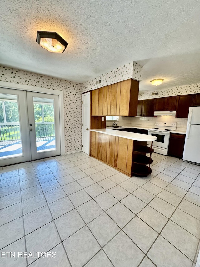 121 Ida Hertzler Ln, Knoxville, TN 37934 - kitchen featuring white appliances, light countertops, a textured ceiling, a peninsula, and french doors