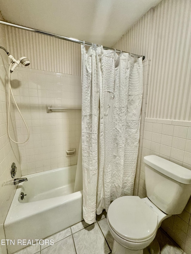 121 Ida Hertzler Ln, Knoxville, TN 37934 - bathroom with shower / bath combo with shower curtain, tile patterned floors, wallpapered walls, wainscoting, and tile walls