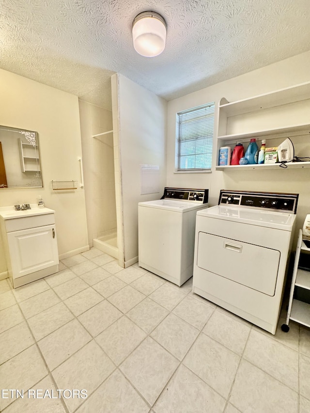 121 Ida Hertzler Ln, Knoxville, TN 37934 - laundry room with washer and dryer, a textured ceiling, and light tile patterned floors
