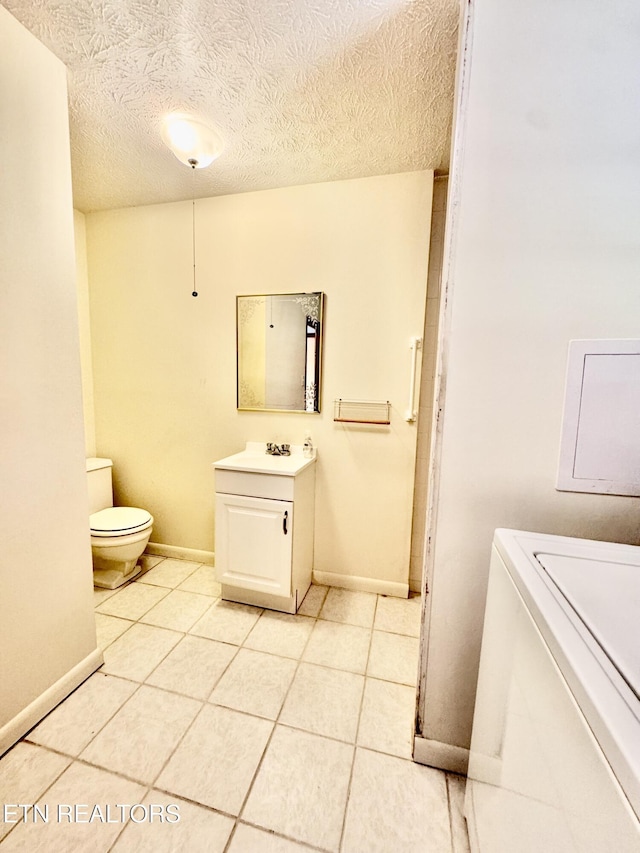 121 Ida Hertzler Ln, Knoxville, TN 37934 - bathroom with vanity, tile patterned floors, a textured ceiling, and washer / dryer