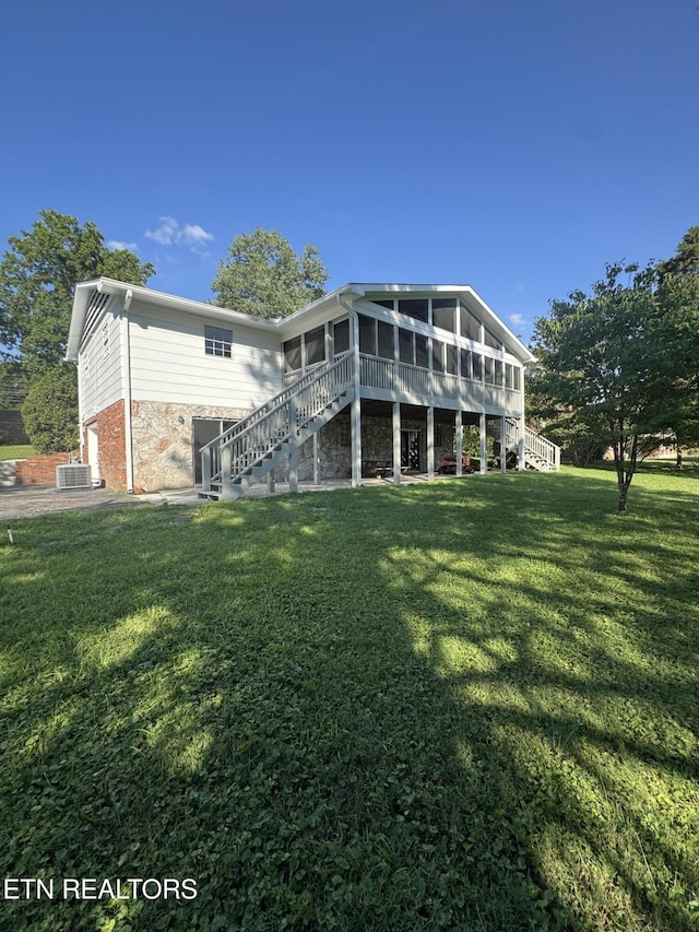 121 Ida Hertzler Ln, Knoxville, TN 37934 - rear view of property with stairs, a sunroom, and a yard