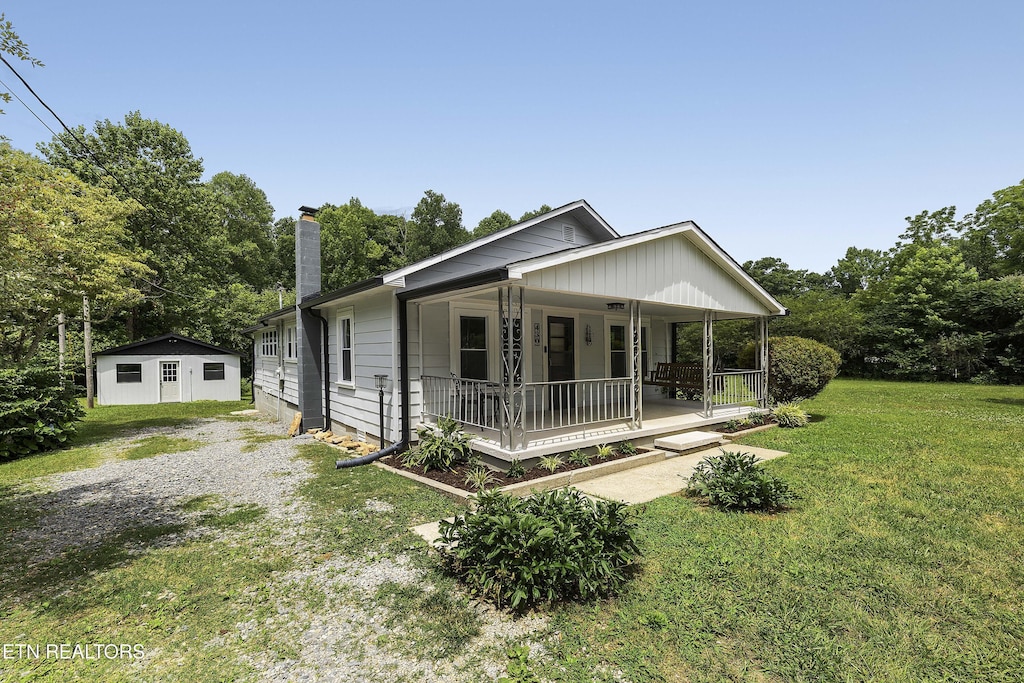 430 Liberty Rd, Wartburg, TN 37887 - bungalow with covered porch, a front yard, and a chimney