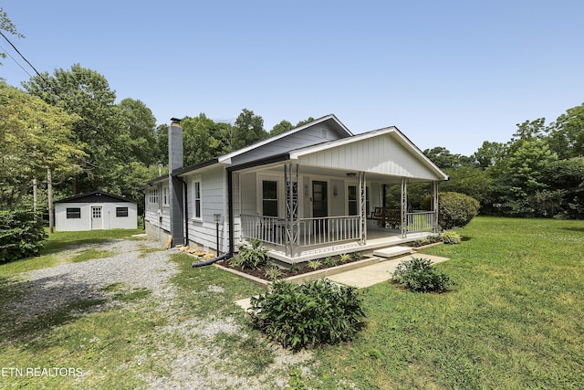 430 Liberty Rd, Wartburg, TN 37887 - bungalow with covered porch, a front yard, and a chimney