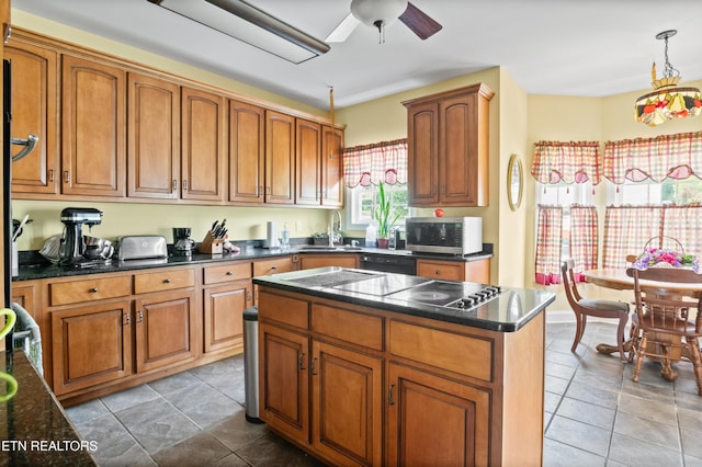 201 Locust Dr, Lafollette, TN 37766 - kitchen with a ceiling fan, brown cabinetry, stainless steel microwave, and stovetop with downdraft