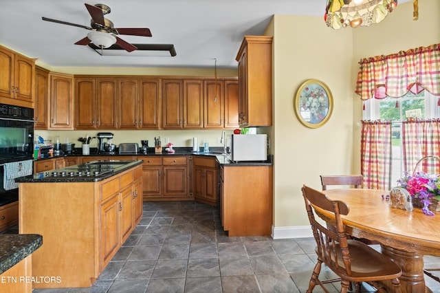 201 Locust Dr, Lafollette, TN 37766 - kitchen featuring black appliances, a ceiling fan, brown cabinets, a center island, and dark stone counters