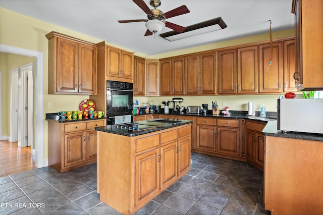 201 Locust Dr, Lafollette, TN 37766 - kitchen with a ceiling fan, a kitchen island, brown cabinetry, and black appliances
