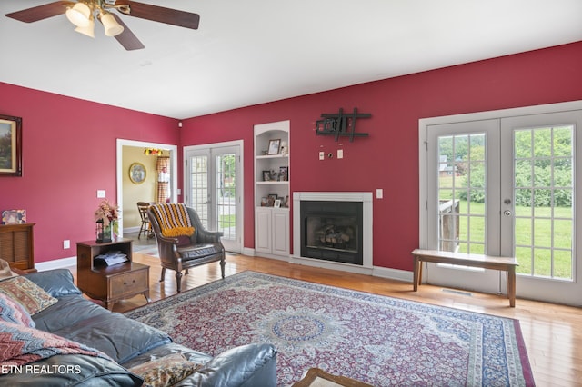 201 Locust Dr, Lafollette, TN 37766 - living room featuring french doors, healthy amount of natural light, wood finished floors, and a ceiling fan