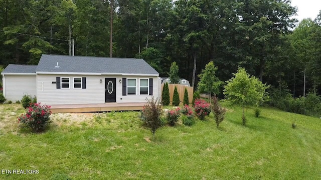 229 Ridge Top Cir, Sunbright, TN 37872 - view of front of house featuring a front lawn, a deck, and a forest view