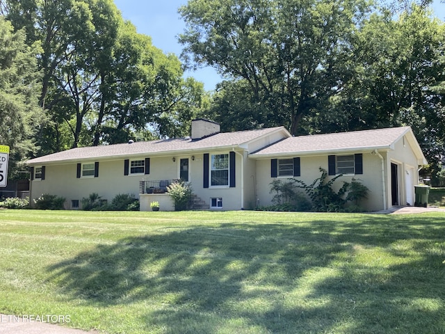 1302 Heron Ave, Maryville, TN 37803 - ranch-style house with an attached garage, a front lawn, a chimney, and stucco siding