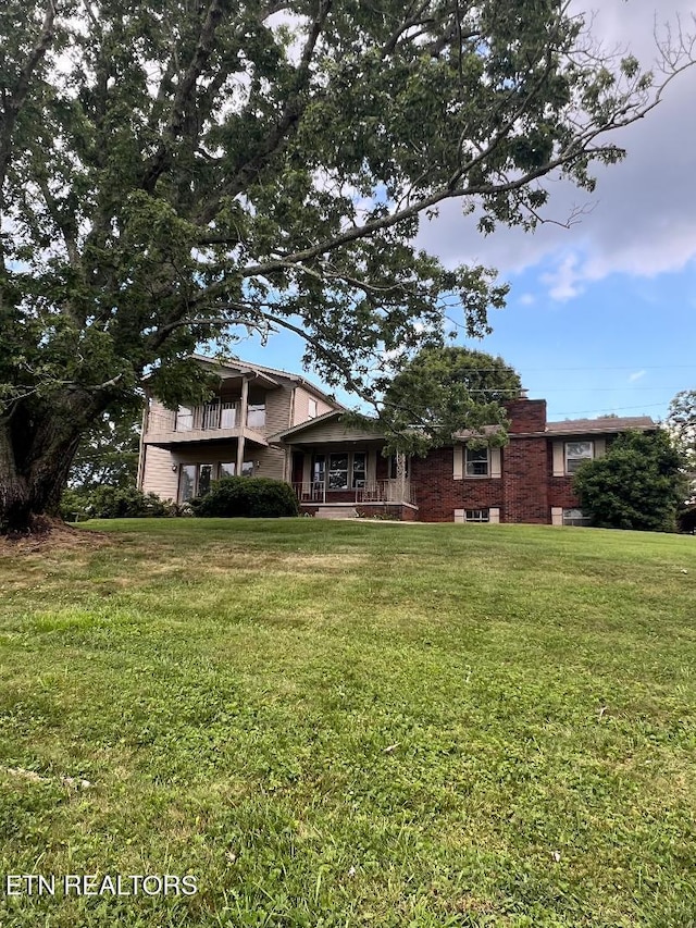 154 Stonehenge St, Harrogate, TN 37752 - view of front facade featuring a front lawn, brick siding, and a porch