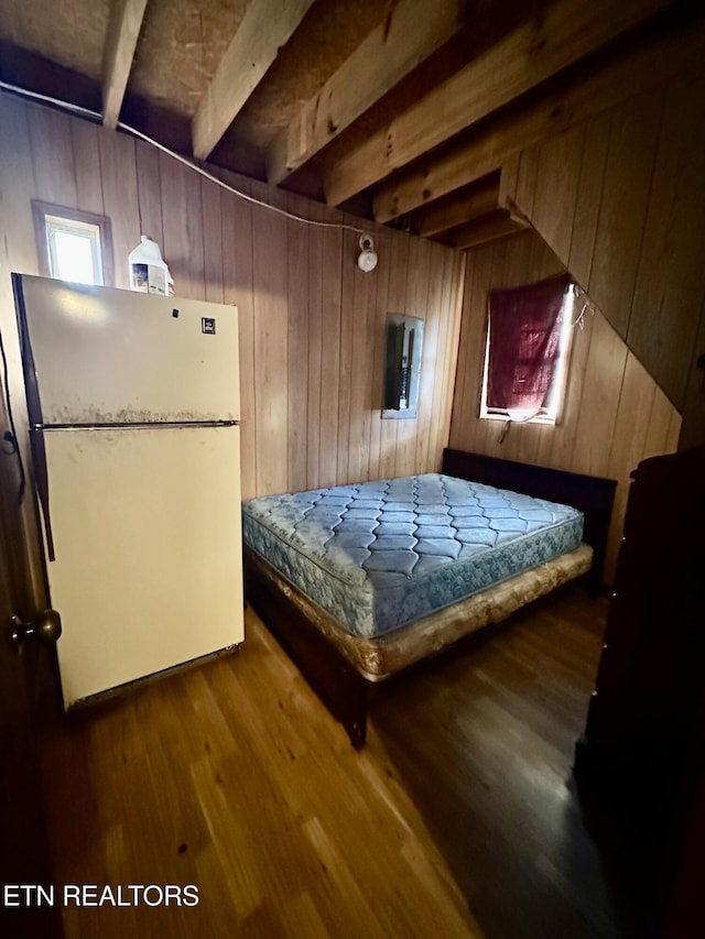 1855 Catoosa Rd, Wartburg, TN 37887 - bedroom featuring freestanding refrigerator, wooden walls, wood finished floors, and beam ceiling