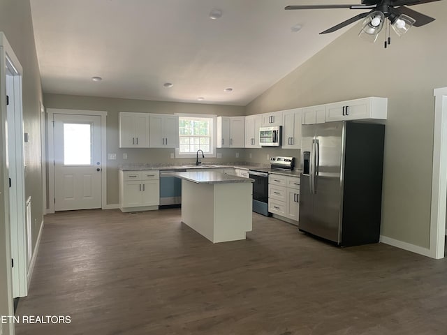 1112 Whispering Pine Ln, Jamestown, TN 38556 - kitchen featuring appliances with stainless steel finishes, white cabinets, a center island, a ceiling fan, and dark wood-type flooring