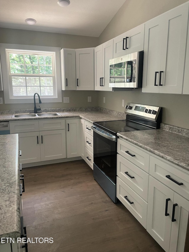 1112 Whispering Pine Ln, Jamestown, TN 38556 - kitchen featuring stainless steel appliances, lofted ceiling, white cabinets, dark wood finished floors, and light countertops