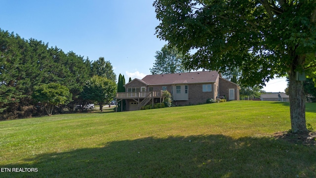 185 Florence Cir, Dandridge, TN 37725 - view of grassy yard with a wooden deck, a garage, and stairway