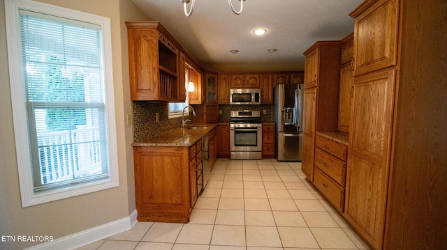 185 Florence Cir, Dandridge, TN 37725 - kitchen with stainless steel appliances, brown cabinetry, light tile patterned floors, backsplash, and recessed lighting