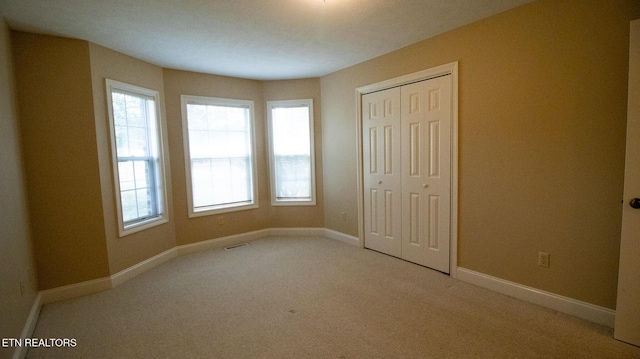 185 Florence Cir, Dandridge, TN 37725 - unfurnished bedroom with light colored carpet, a closet, and multiple windows