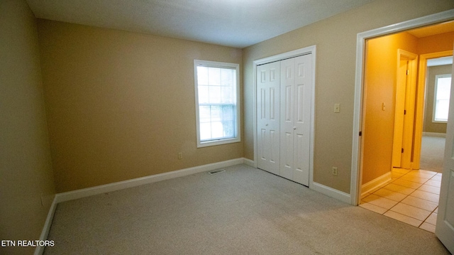 185 Florence Cir, Dandridge, TN 37725 - unfurnished bedroom with multiple windows, carpet flooring, and a closet