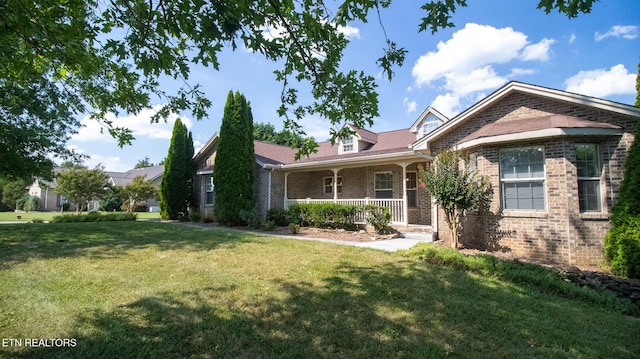 185 Florence Cir, Dandridge, TN 37725 - view of front of house featuring a porch, brick siding, and a front lawn