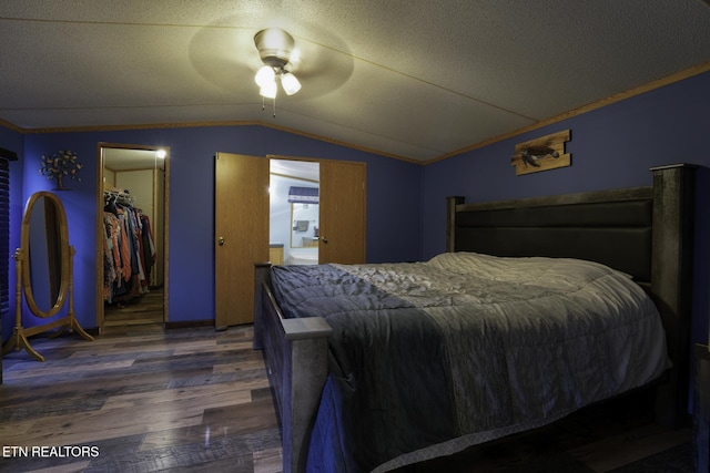 1872 Mitchell Farm Rd, Sevierville, TN 37876 - bedroom with wood finished floors, vaulted ceiling, a walk in closet, ceiling fan, and a textured ceiling