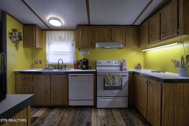 1872 Mitchell Farm Rd, Sevierville, TN 37876 - kitchen featuring white appliances, under cabinet range hood, a textured ceiling, dark wood-type flooring, and brown cabinetry