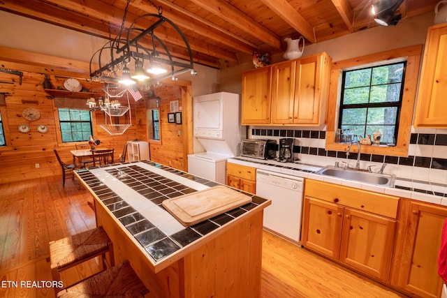 861 Windy Hill Way, Cosby, TN 37722 - kitchen featuring tile counters, dishwasher, stacked washer / dryer, wooden walls, and light wood-type flooring