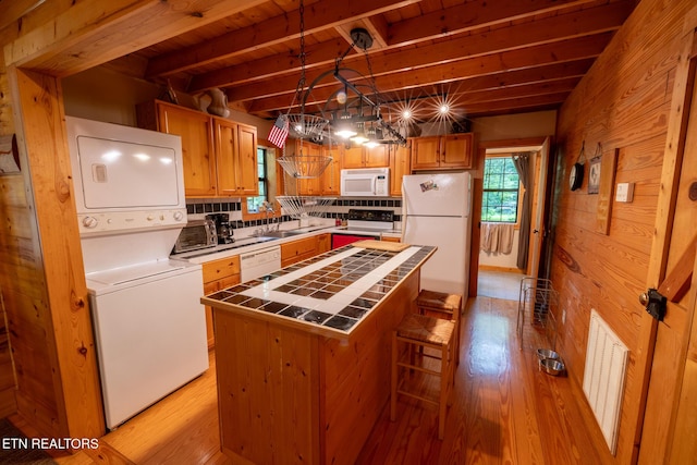 861 Windy Hill Way, Cosby, TN 37722 - kitchen featuring white appliances, tile countertops, stacked washing machine and dryer, a wooden ceiling with exposed beams, and light wood finished floors