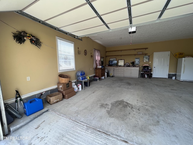 142 Lone Holly Ln, New Tazewell, TN 37825 - garage with freestanding refrigerator and a garage door opener