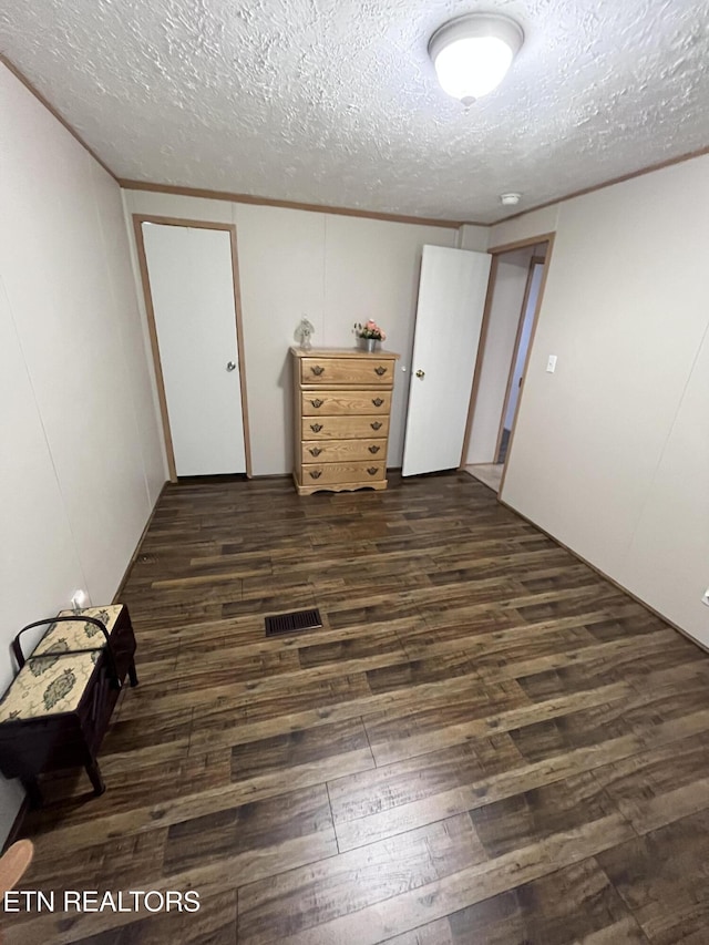 142 Lone Holly Ln, New Tazewell, TN 37825 - empty room featuring a textured ceiling, dark wood-style floors, and ornamental molding