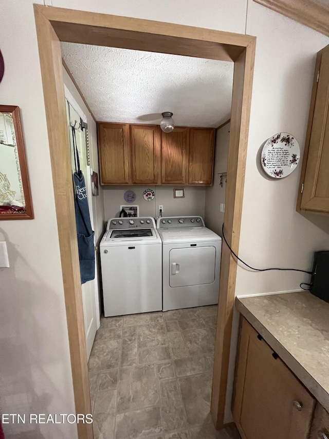 142 Lone Holly Ln, New Tazewell, TN 37825 - laundry area featuring cabinet space, independent washer and dryer, a textured ceiling, and stone finish flooring
