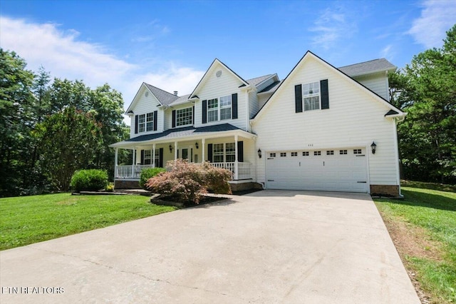 440 Indian Hills Rd, Oneida, TN 37841 - view of front of home featuring concrete driveway, covered porch, a garage, and a front lawn