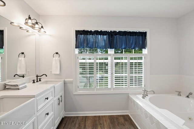 440 Indian Hills Rd, Oneida, TN 37841 - full bathroom featuring plenty of natural light, double vanity, a bath, and wood finished floors