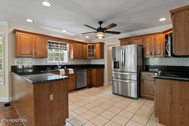 440 Indian Hills Rd, Oneida, TN 37841 - kitchen featuring stainless steel appliances, brown cabinets, a peninsula, crown molding, and a ceiling fan