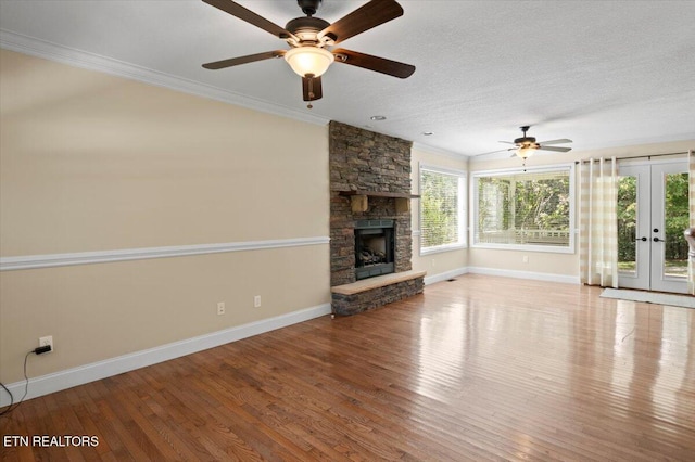 440 Indian Hills Rd, Oneida, TN 37841 - unfurnished living room with french doors, ornamental molding, ceiling fan, wood finished floors, and a fireplace