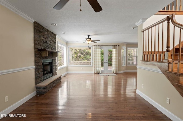 440 Indian Hills Rd, Oneida, TN 37841 - unfurnished living room featuring a ceiling fan, crown molding, french doors, stairway, and a fireplace