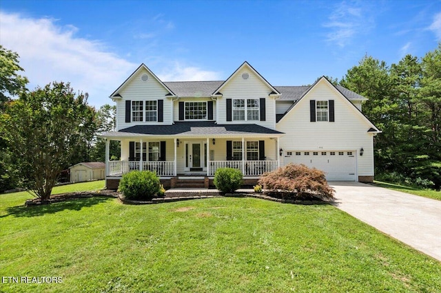 440 Indian Hills Rd, Oneida, TN 37841 - view of front of home with a porch, a garage, driveway, a storage unit, and a front lawn