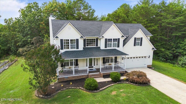 440 Indian Hills Rd, Oneida, TN 37841 - traditional-style home with a porch, concrete driveway, an attached garage, a front yard, and a chimney