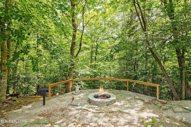 1721 Holly Bend Dr, Byrdstown, TN 38549 - view of patio / terrace with an outdoor fire pit and a view of trees