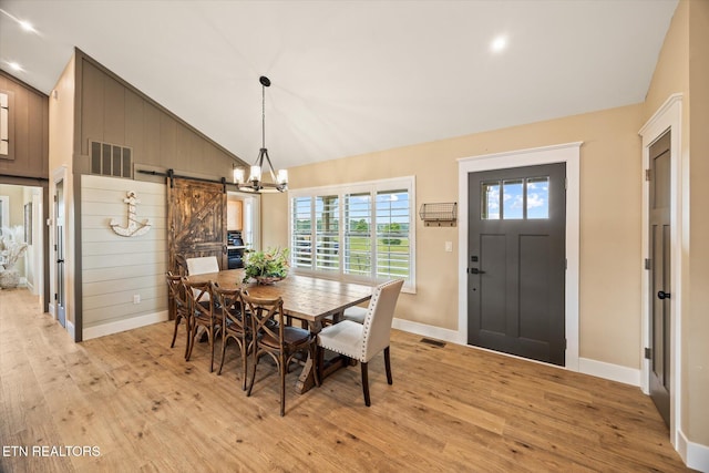 1721 Holly Bend Dr, Byrdstown, TN 38549 - dining room featuring light wood-type flooring, a barn door, a chandelier, recessed lighting, and high vaulted ceiling