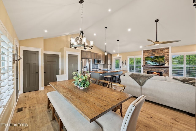 1721 Holly Bend Dr, Byrdstown, TN 38549 - dining room with light wood-type flooring, a fireplace, recessed lighting, healthy amount of natural light, and ceiling fan