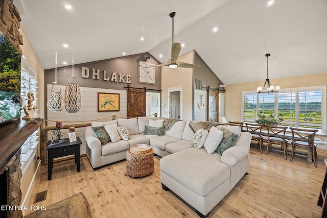 1721 Holly Bend Dr, Byrdstown, TN 38549 - living area with a barn door, high vaulted ceiling, light wood-style flooring, recessed lighting, and a chandelier