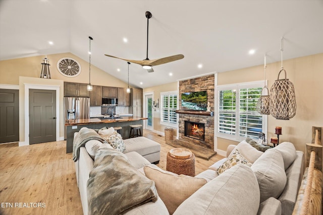 1721 Holly Bend Dr, Byrdstown, TN 38549 - living room with light wood-style flooring, ceiling fan, recessed lighting, high vaulted ceiling, and a stone fireplace