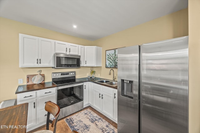 1721 Holly Bend Dr, Byrdstown, TN 38549 - kitchen featuring stainless steel appliances, white cabinetry, and wood finished floors