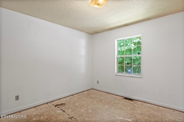 546 Park Rd, Caryville, TN 37714 - spare room featuring a textured ceiling and baseboards