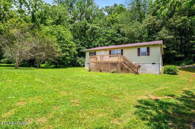 546 Park Rd, Caryville, TN 37714 - view of front of house with crawl space, a deck, stairs, and a front lawn