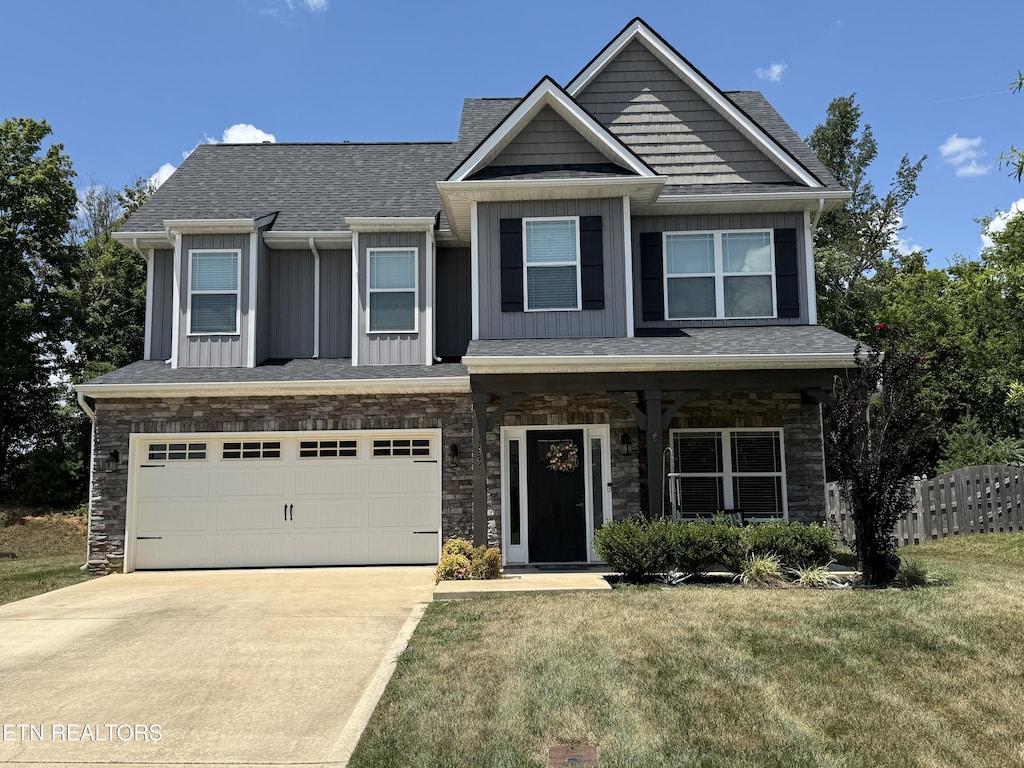 1139 Aspen Glen Dr, Alcoa, TN 37701 - craftsman inspired home featuring concrete driveway, an attached garage, stone siding, board and batten siding, and a shingled roof