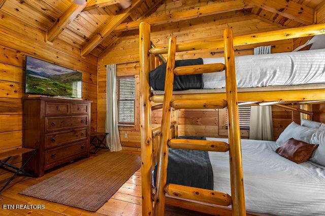 3322 Covered Bridge Way, Sevierville, TN 37862 - bedroom featuring wood ceiling, hardwood / wood-style flooring, and wooden walls