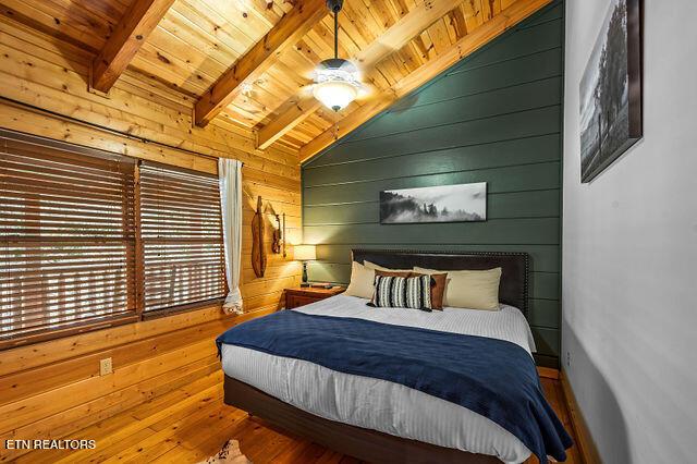 3322 Covered Bridge Way, Sevierville, TN 37862 - bedroom featuring wood ceiling, wood walls, and wood-type flooring