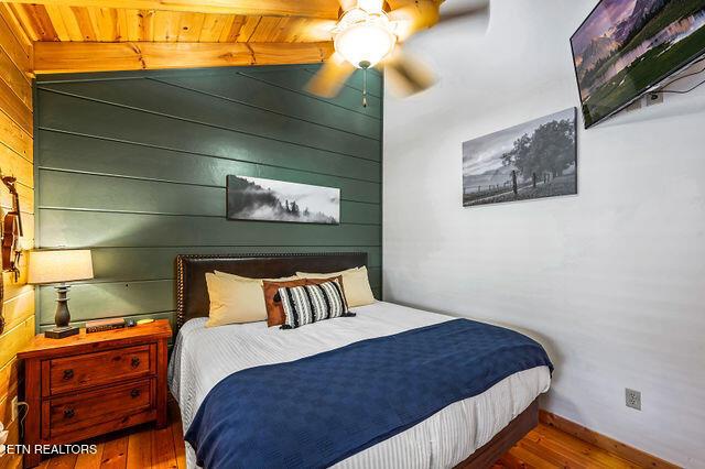 3322 Covered Bridge Way, Sevierville, TN 37862 - bedroom featuring wood finished floors, wood walls, and ceiling fan