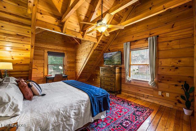 3322 Covered Bridge Way, Sevierville, TN 37862 - bedroom featuring wooden walls, hardwood / wood-style flooring, and wood ceiling