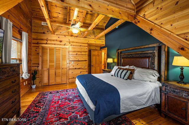 3322 Covered Bridge Way, Sevierville, TN 37862 - bedroom featuring hardwood / wood-style floors, wooden walls, and wooden ceiling